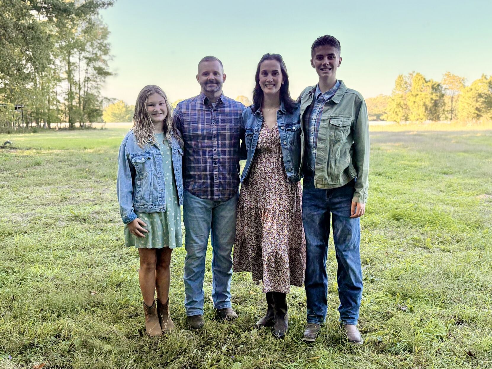The Schlitter family standing together at Risen Acres